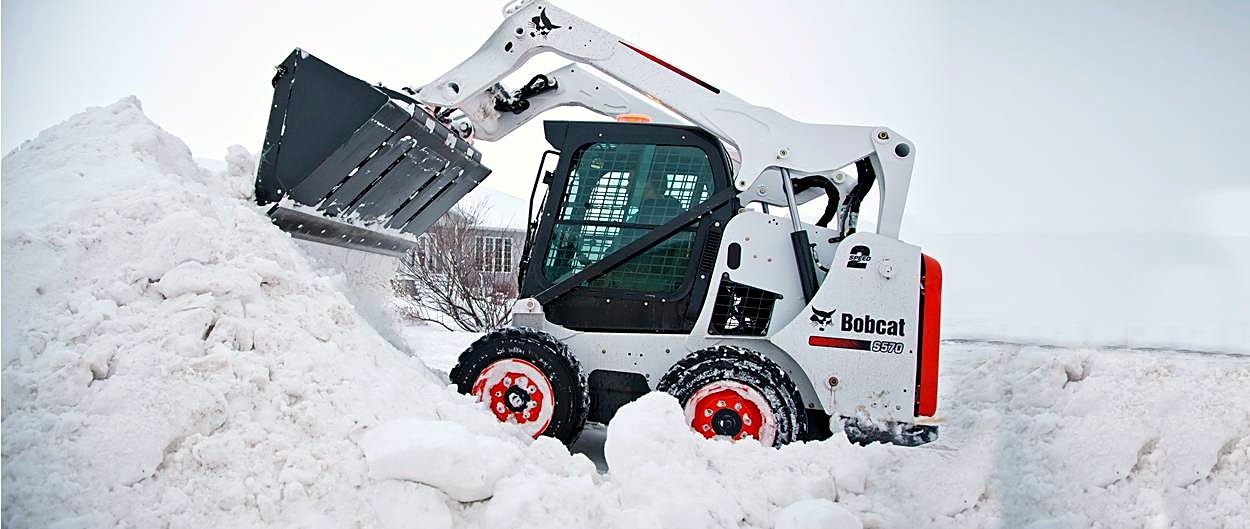 Skid steer clearing snow